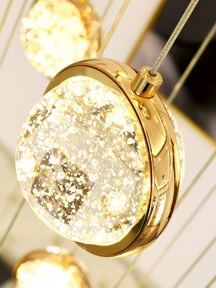 Modern gold bubble ball chandelier in foyer staircase, spiral K9 crystal spheres for two-story high ceiling