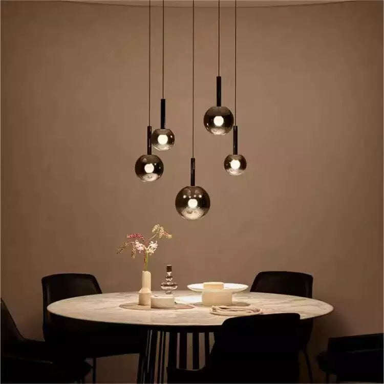 Glass gradient pendant lights, featuring black gradient spherical lampshades, are available in various sizes and are suitable for spaces with high ceilings such as restaurants and entryways.