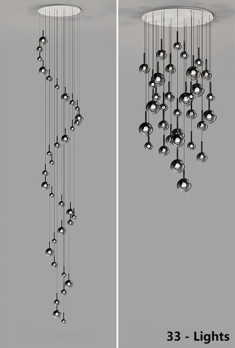
33 custom-made gradient glass pendant lights, suitable for entrance halls, featuring black gradient spherical lampshades in various sizes, ideal for stairwells or high-ceilinged foyers.