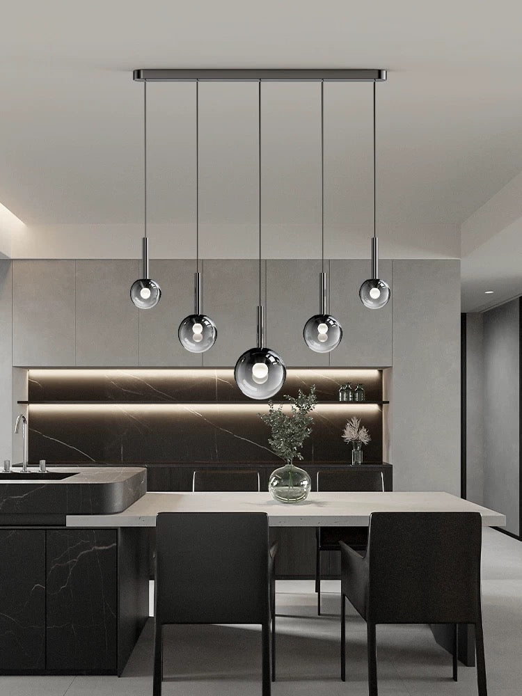 Modern kitchen with pendant lights and black furniture