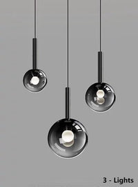 Thumbnail for Three luxurious pendant lights with gradient-colored glass shades, suitable for dining tables and entryways. The black gradient spherical lampshades come in varying sizes, ideal for relatively smaller spaces.