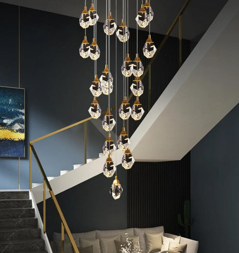 Brass irregular crystal chandelier installed in modern two-story foyer, raw-cut K9 prisms high ceiling lighting
