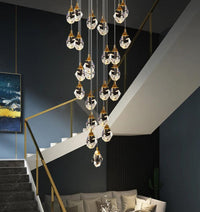 Thumbnail for Brass irregular crystal chandelier installed in modern two-story foyer, raw-cut K9 prisms high ceiling lighting