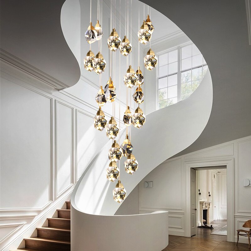 Real K9 crystal chandelier with irregular raw-cut prisms, natural brass finish for luxury foyer stairwell