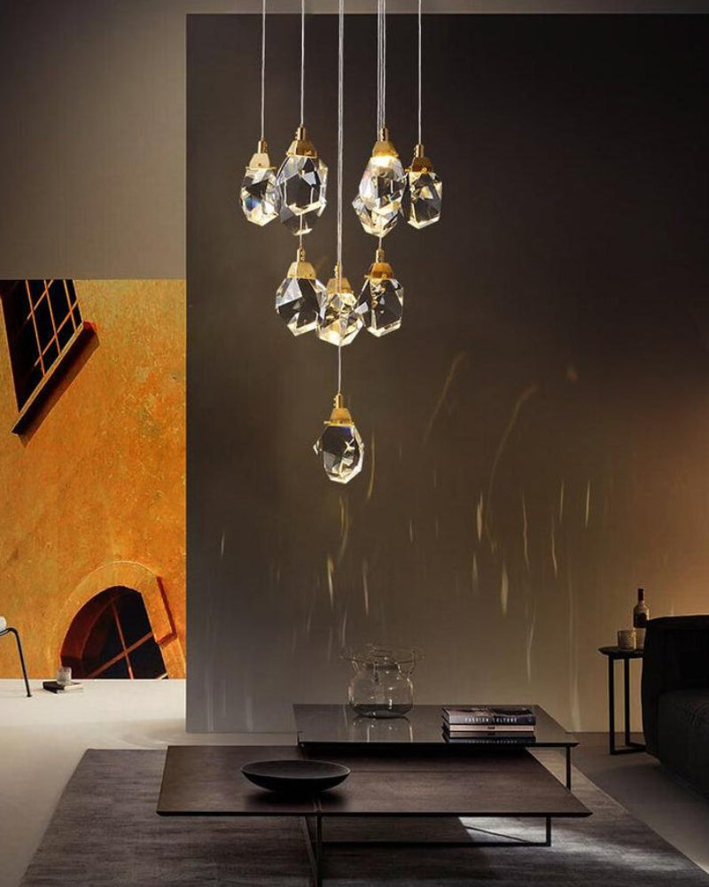 Irregular crystal chandelier lighting detail, brass finish with raw-cut K9 prisms for modern interior lighting