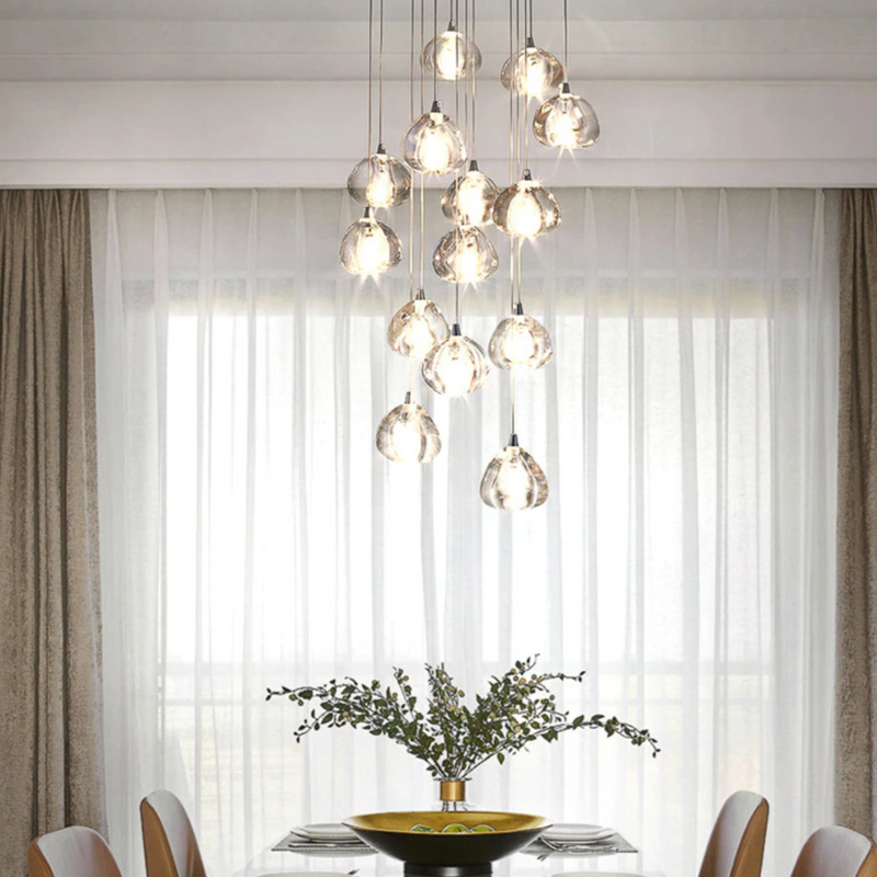 A luxurious crystal chandelier with multiple hanging light fixtures, designed for staircase or large space lighting.