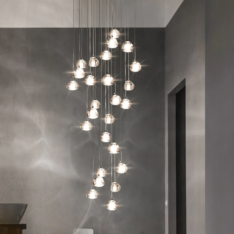 Unique American bubble crystal chandelier with varying heights creating visual depth for staircase foyer entryway two-story space
