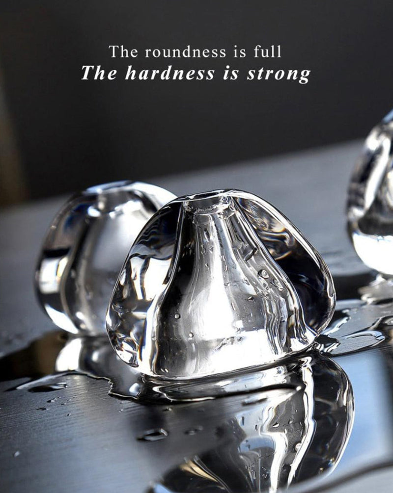 Clear crystal objects on a reflective surface with text overlay