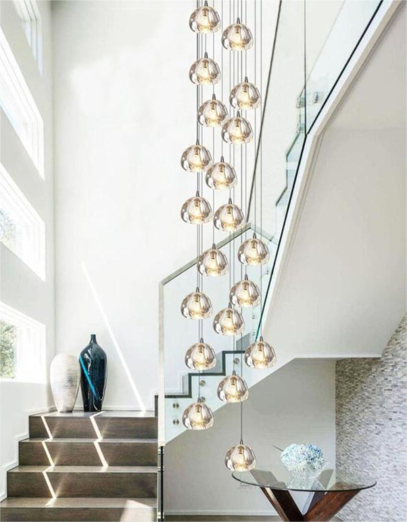 Round American crystal chandelier with cascading multi-light design creating brilliant refraction for staircase foyer entryway