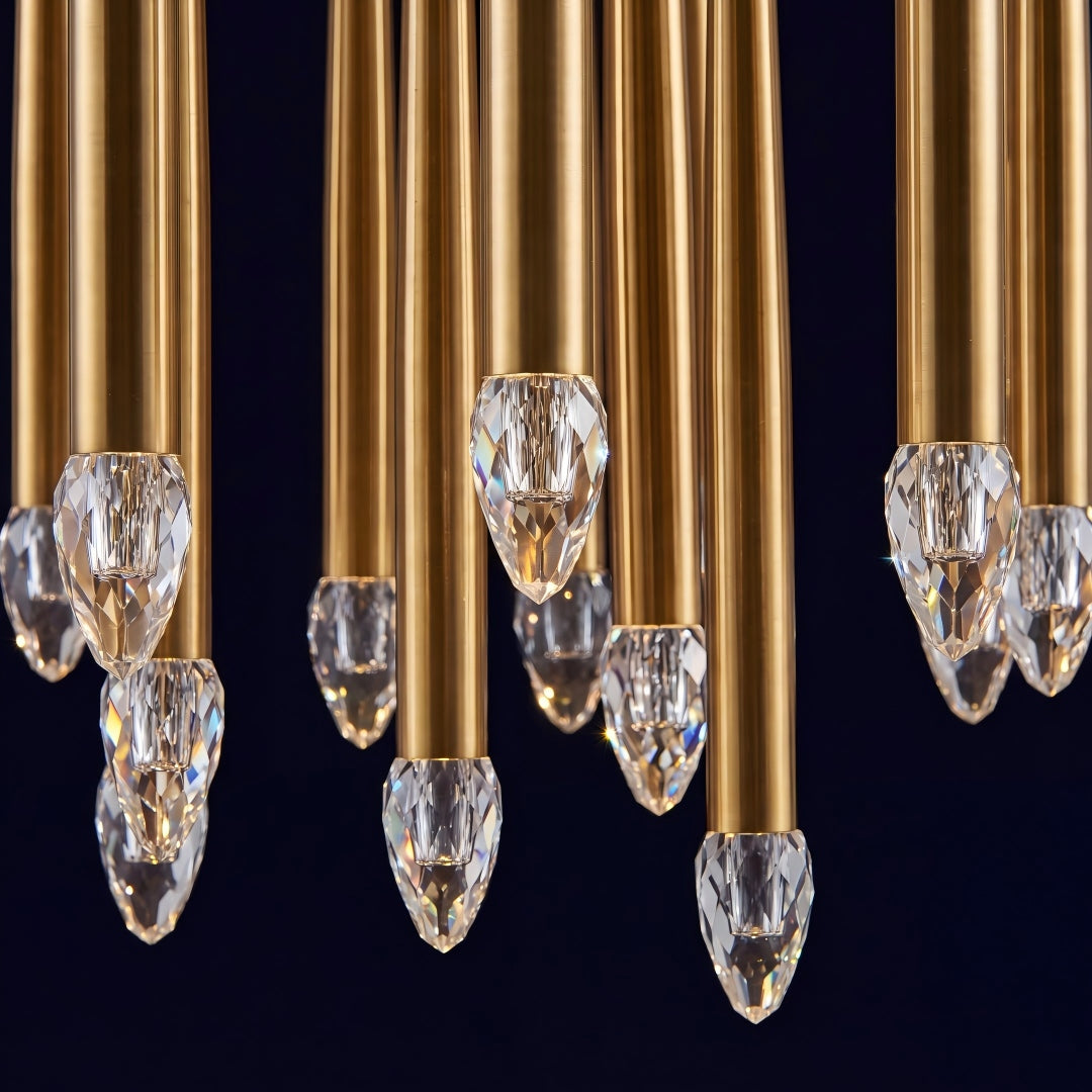 Gold chandelier with crystal drops against a black background