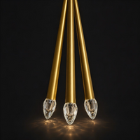 Thumbnail for Three gold pendant lights with crystal-like ends on a black background