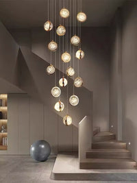 Thumbnail for A modern gold-colored chandelier with a bubble crystal design, featuring multiple suspended crystals and LED lighting, intended for staircase or entrance hall illumination.