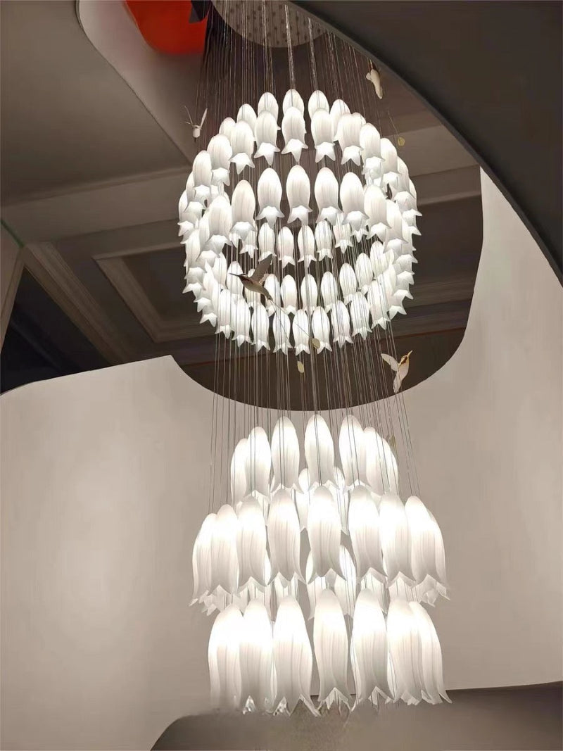 Ambient ceramic blossom lighting solution with graceful hummingbird elements for staircase foyer entryway two-story space