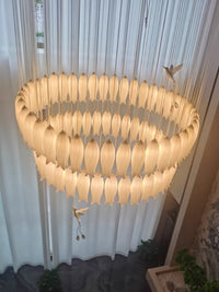 Thumbnail for Luxurious ceramic flower chandelier illuminating stairway with layered petals and hummingbird accents for foyer entryway,warm light illuminates the scene (real photos).