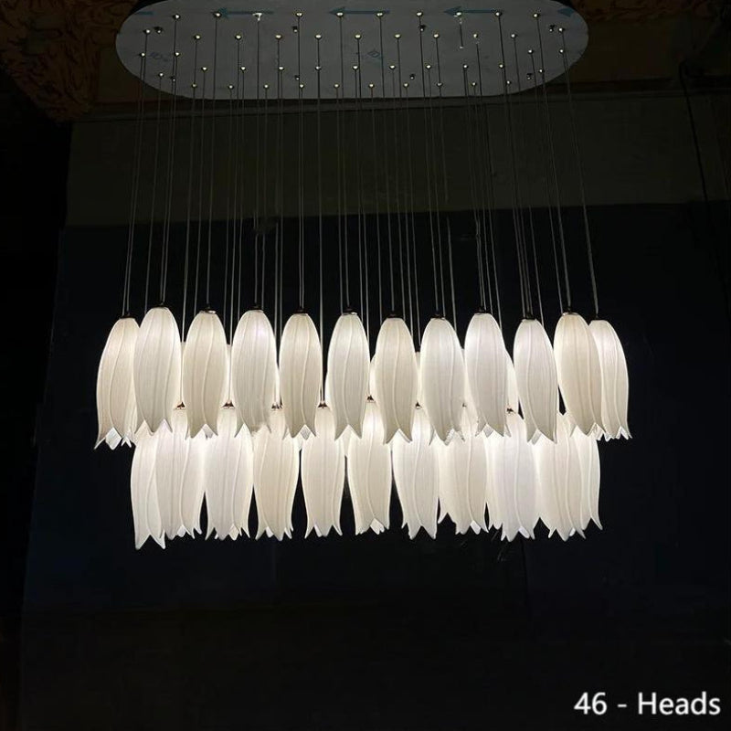 This ceramic floral pendant lamp, shimmering with golden light and adorned with delicate hummingbird motifs, is perfect for installation above a dining room island.