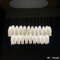 Thumbnail for This ceramic floral pendant lamp, shimmering with golden light and adorned with delicate hummingbird motifs, is perfect for installation above a dining room island.