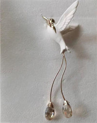 Thumbnail for White bird-shaped earring with crystal droplets on a light gray background