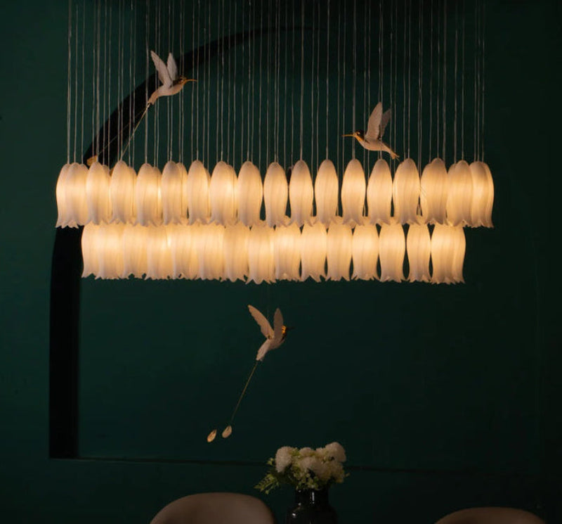 Modern ceramic blossom chandelier with innovative hummingbird elements adding contemporary twist to staircase foyer lighting