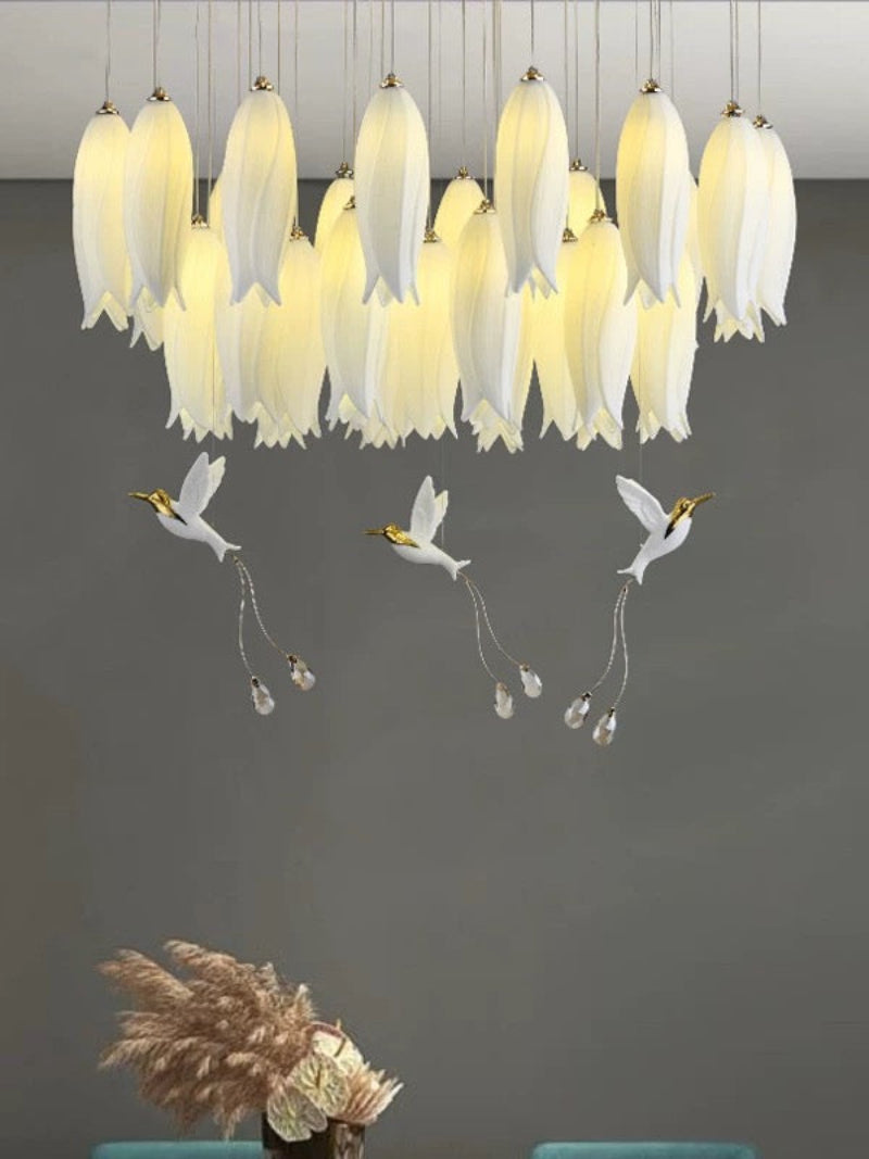 Stunning layered ceramic flower centerpiece with nature-inspired hummingbird accents for grand staircase foyer lighting