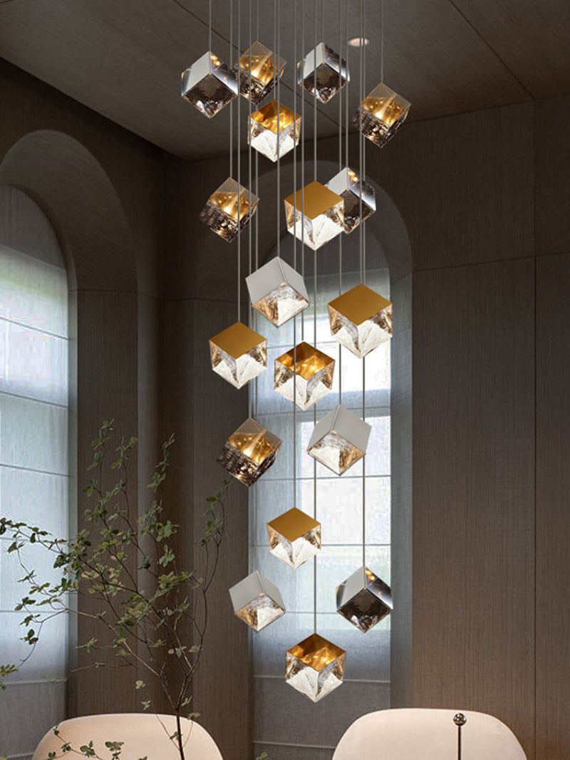 A golden, ice-cube-shaped glass pendant light with a textured design that creates a rippling water effect, suitable for staircases and entryways.