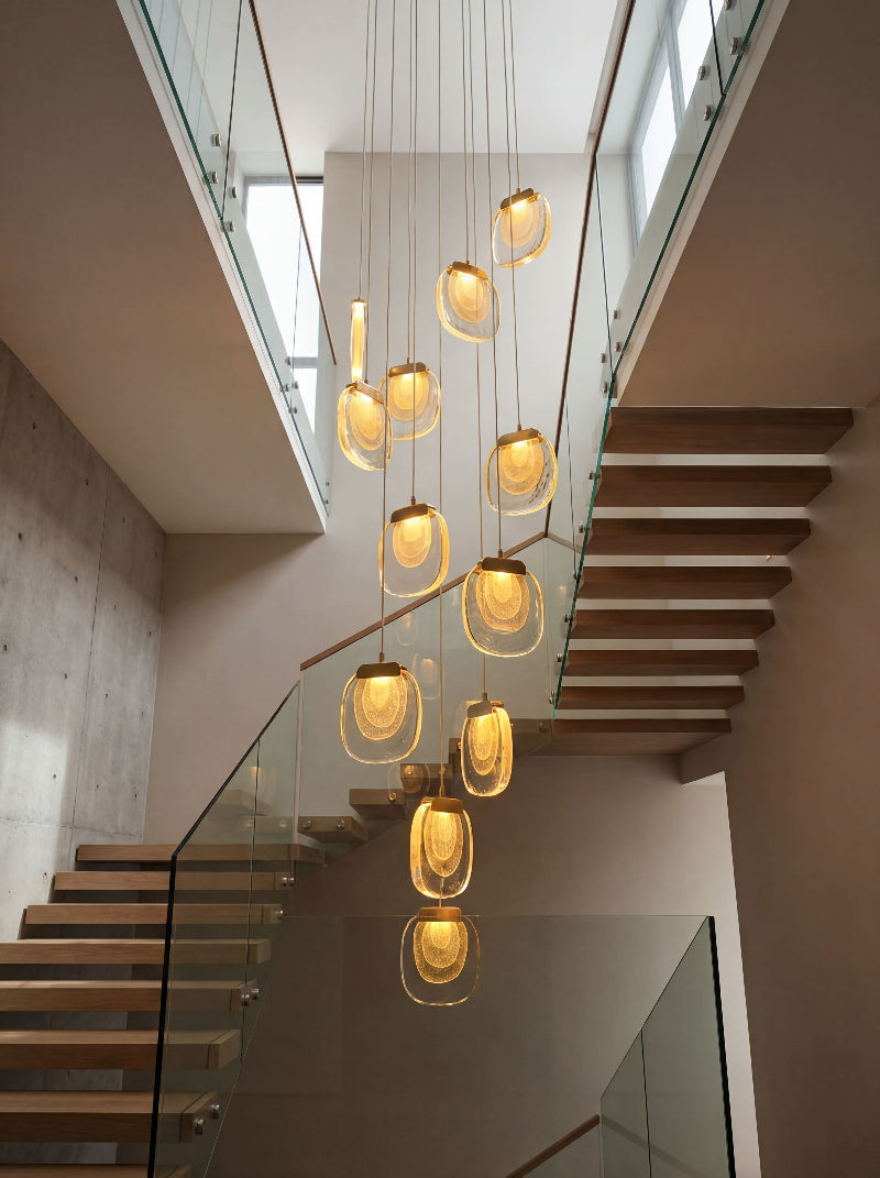 Designer golden cascade crystal pendant featuring multi-level waterfall arrangement for sophisticated dining room foyer lighting