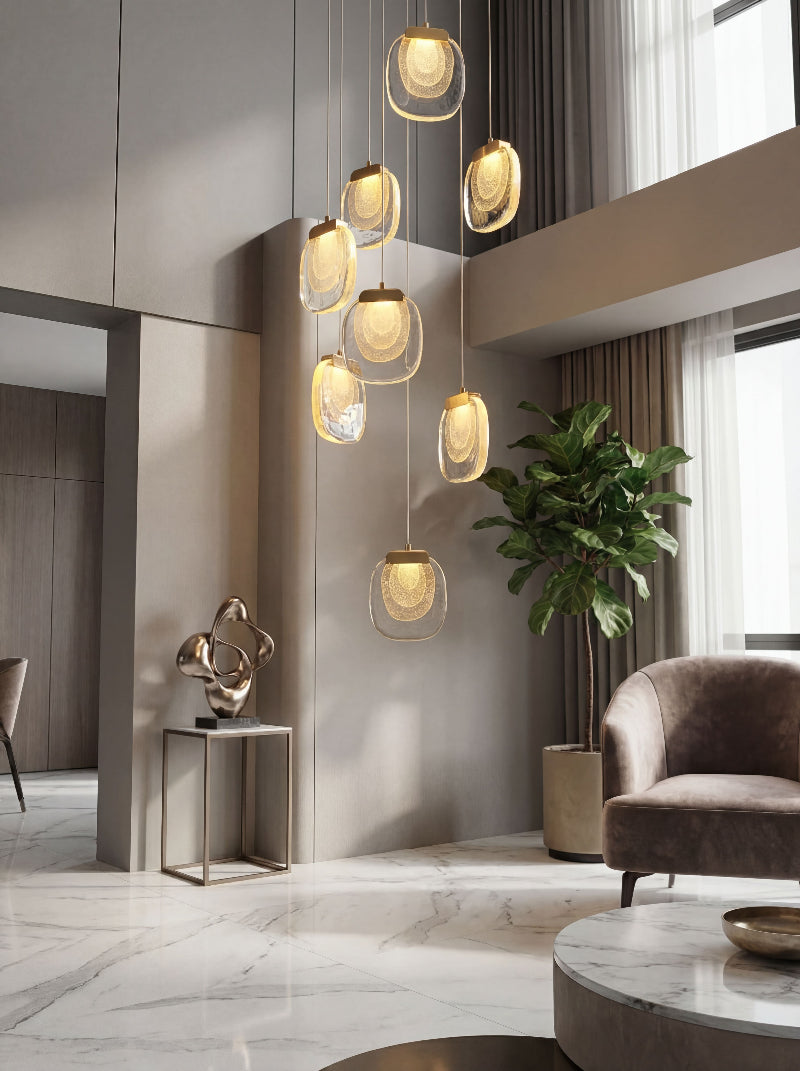 Artistic gold cascade chandelier with flowing crystal tiers creating elegant waterfall effect for grand foyer staircase lighting