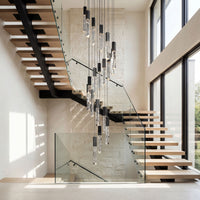 Thumbnail for Architectural LED linear K9 crystal rod chandelier with adjustable height creating statement lighting in two-story foyer entryway