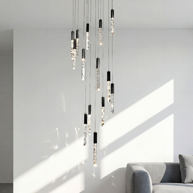Premium LED linear K9 crystal chandelier with waterfall rod design creating dramatic illumination in luxury foyer stairwell void