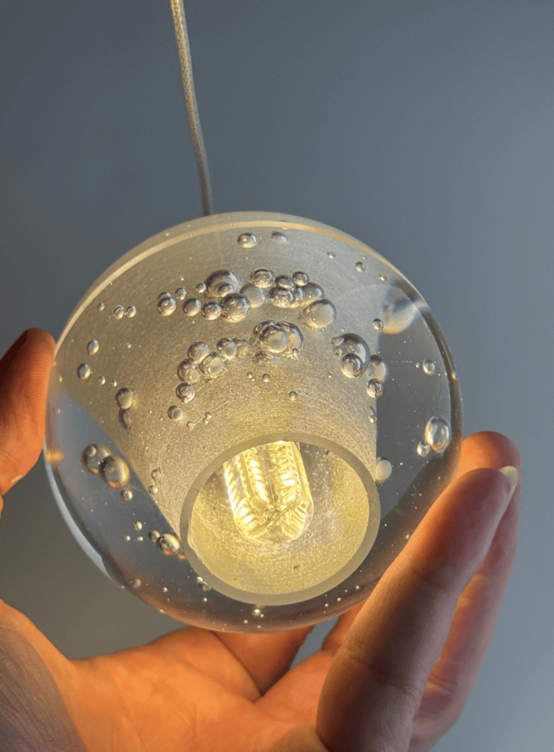 a dimmable LED suspended spherical light is ideal for high-ceiling areas in entrance halls.  Single-head crystal close-up includes the light source.