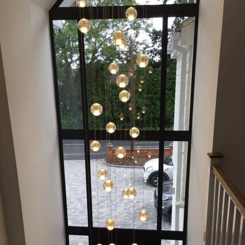 Chrome-plated hardware paired with a bubble crystal chandelier, suitable for modern foyers.  Features a dimmable LED suspended spherical light, ideal for high ceilings in stairwells and entryways.  Warm light shown in the photos.