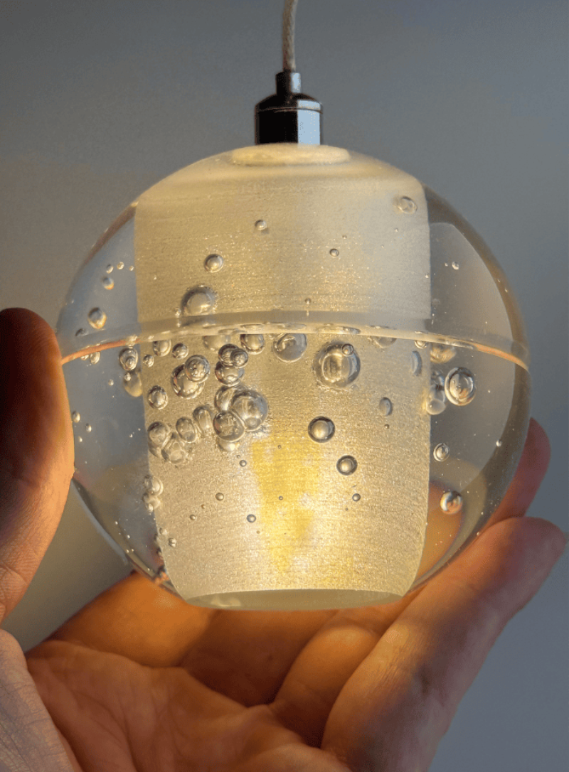 An artistic chrome-plated bubble crystal chandelier with dimmable LED suspended spherical lights, suitable for stairwells, foyers, or spaces with high ceilings.  Single-head crystal warm light effect shown.