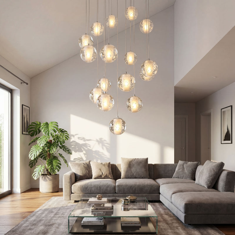 Luxury chrome bubble crystal chandelier with dimmable LED floating orbs creating elegant ambiance in grand residential staircase foyer