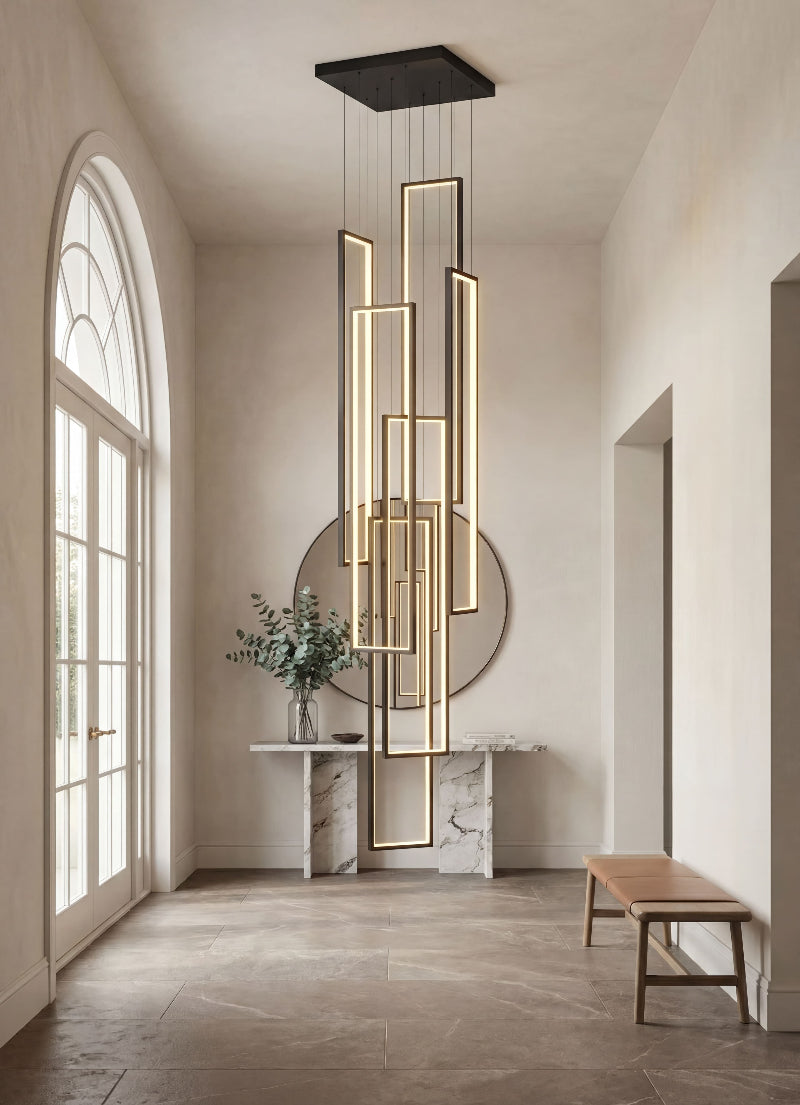 Artistic black geometric LED chandelier with minimalist interlocking rectangles creating dramatic lighting installation in modern high ceiling foyer