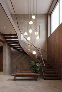 Thumbnail for Modern gold glass globe chandelier cluster with frosted white shades creating sophisticated ambient lighting in contemporary entryway