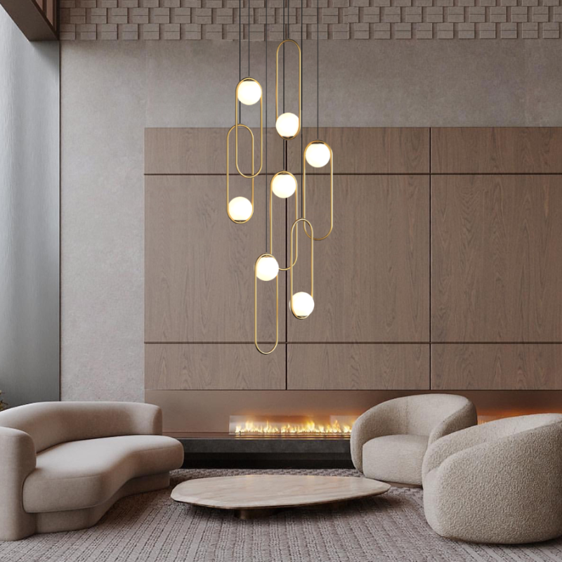 Gold 7-light glass globe foyer chandelier near fireplace with golden metal frame creating luxury entryway lighting ambiance