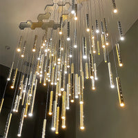 Thumbnail for 
Above the dining table hangs a silver, linear, cylindrical pendant lamp, designed to resemble a meteor shower, with perforated light tubes, creating a modern interior atmosphere.
