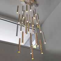 Thumbnail for The silver linear cylindrical pendant lights in the stairwell feature a meteor shower design and perforated light tubes, making them suitable for commercial spaces such as staircases.