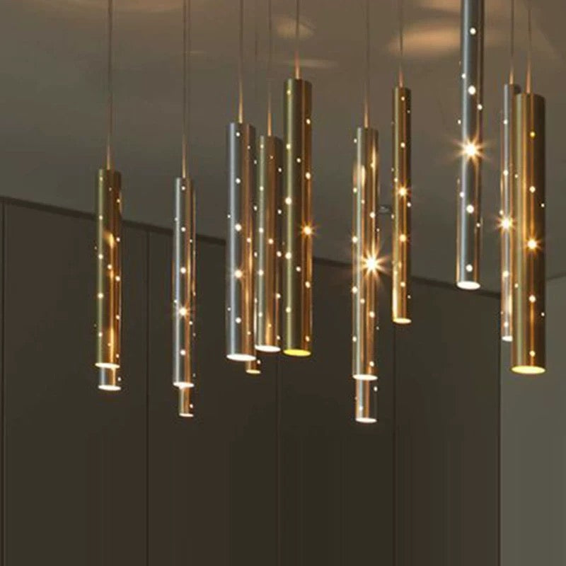 Silver linear cylindrical pendant lights with perforated meteor shower design for kitchen island and dining table lighting