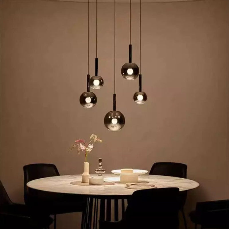 Glass gradient pendant lights, featuring black gradient spherical lampshades, are available in various sizes and are suitable for spaces with high ceilings such as restaurants and entryways.