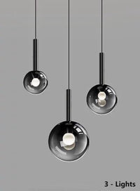 Thumbnail for Three luxurious pendant lights with gradient-colored glass shades, suitable for dining tables and entryways. The black gradient spherical lampshades come in varying sizes, ideal for relatively smaller spaces.