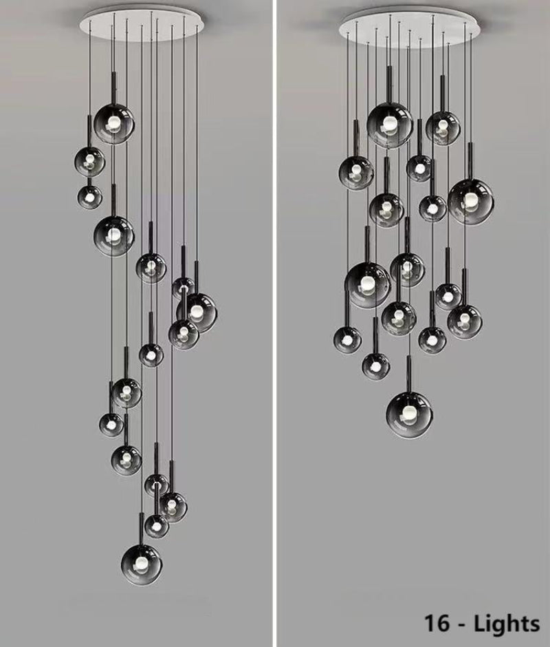 This 16-light bubble pendant lamp features gradient black glass spheres of varying sizes, available in both random and spiral arrangements.  It is ideal for illuminating high-ceiling spaces such as stairwells and foyers.