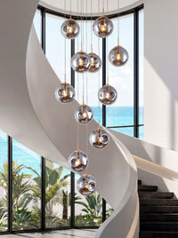 Thumbnail for Artisan Murano-style glass chandelier with sculptural bubble design creating brilliant ambient lighting in luxury two-story foyer entryway