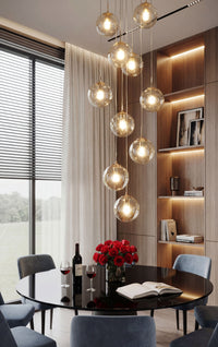 Thumbnail for Designer Murano-style glass chandelier with concave-convex bubble design creating dramatic lighting in contemporary stairwell void