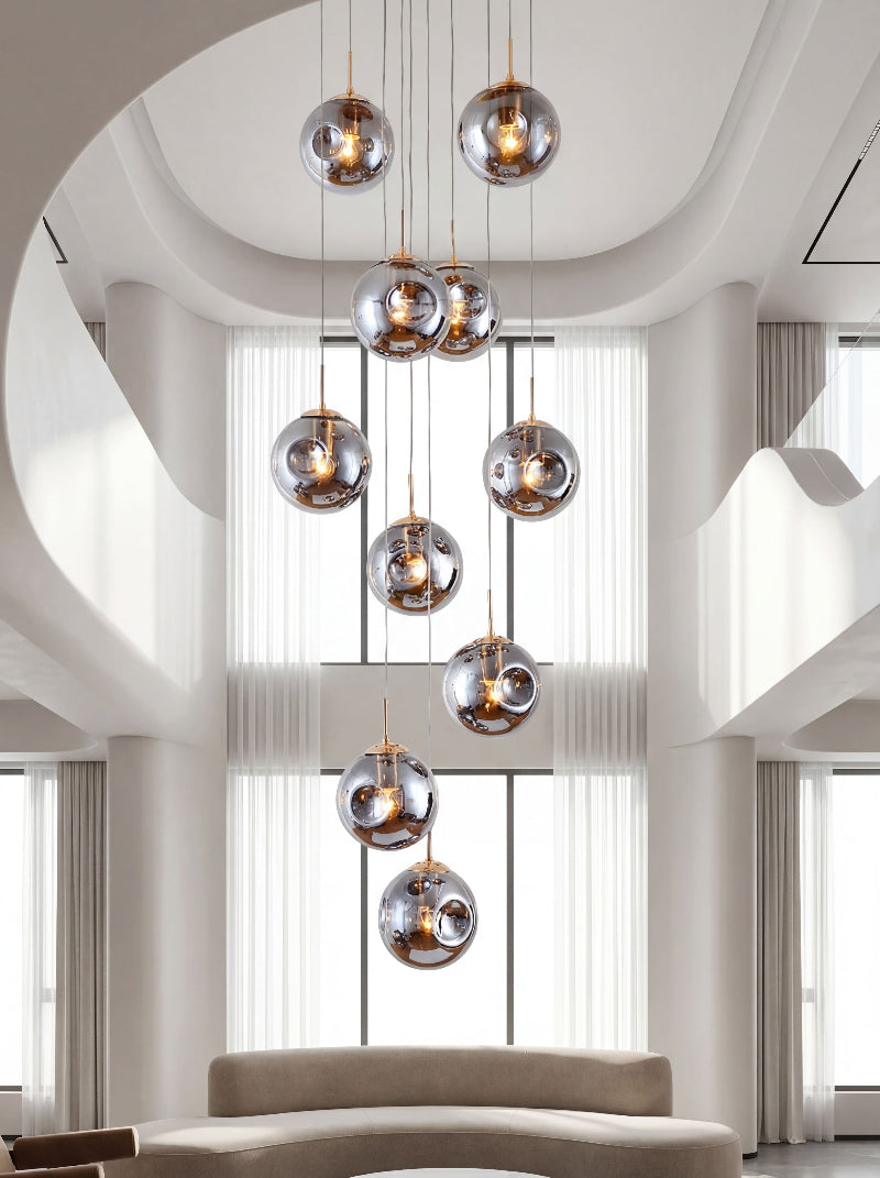 Contemporary Murano-style glass chandelier with concave-convex bubble design creating cascading lighting in modern two-story foyer staircase