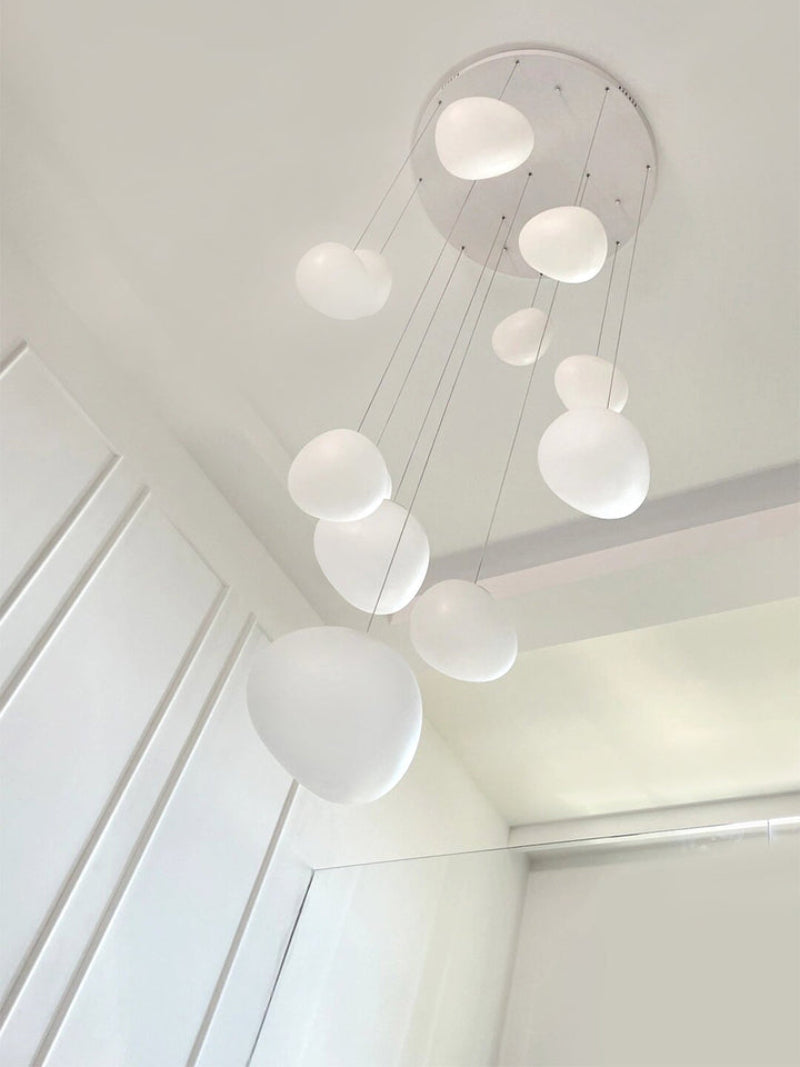 Stellar pendant bringing cosmic light and modern style to staircase with mixed-size white spheres for foyer high ceiling