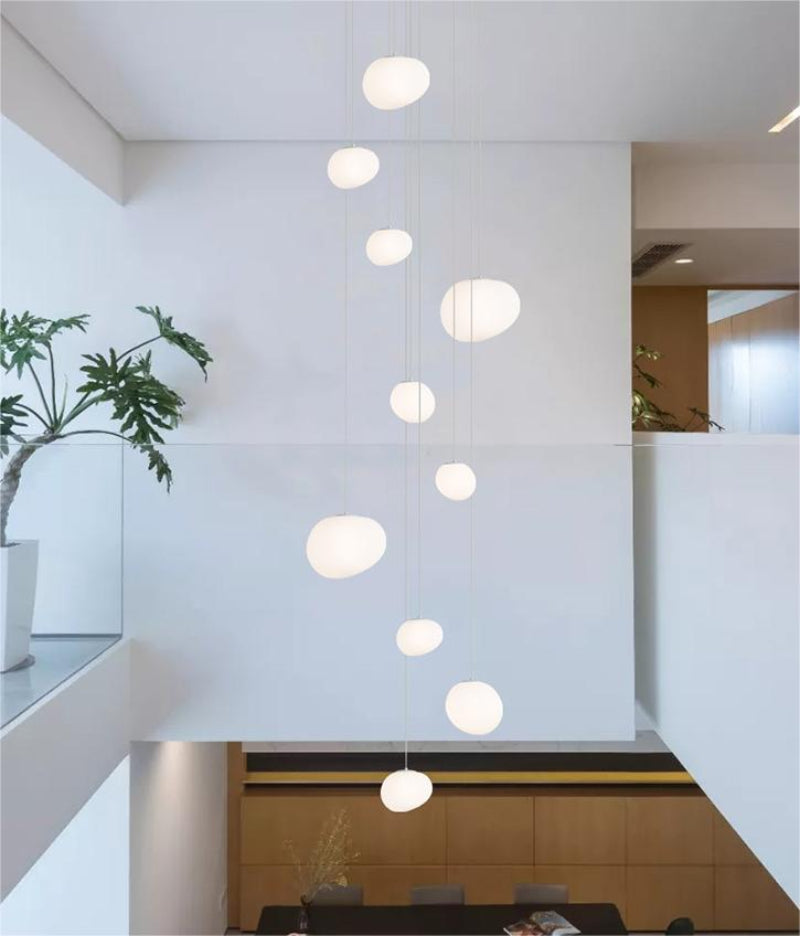 Functional stellar chandelier combining artistic celestial design with soft illumination for stairwell foyer two-story ceiling