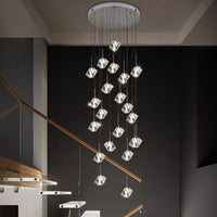 Thumbnail for A contemporary style chandelier with multiple clear crystal cube-shaped lights suspended at various heights, emitting a warm glow, ideal for modern interior settings.
