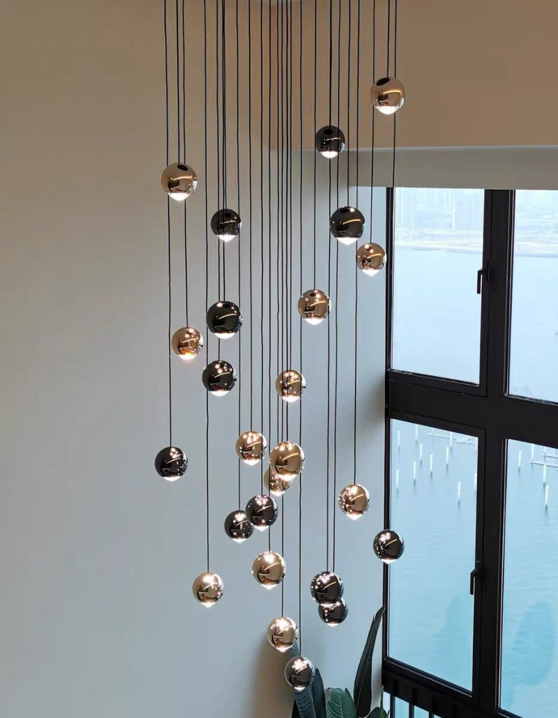 Contemporary stair chandelier featuring cognac glass chocolate spheres with aluminum K9 crystal for foyer entryway ceiling