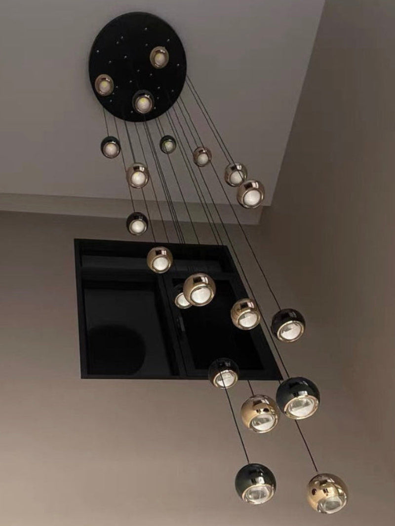 Grand stair chandelier with cognac glass chocolate clusters in gold finish creating opulent atmosphere for foyer entryway