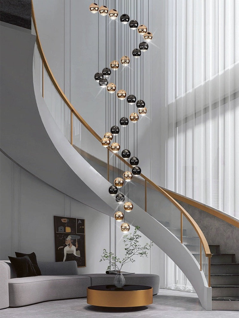 Contemporary stair chandelier with cognac glass chocolate balls in gold finish for modern foyer entryway two-story ceiling